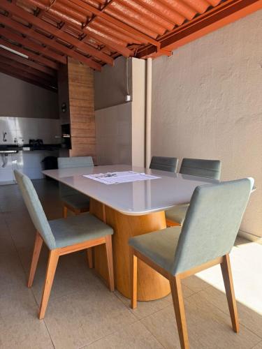 a table and chairs in a room with a kitchen at Casa Canto do Araguaia in Barra do Garças