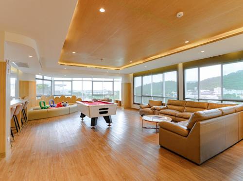 a large living room with couches and a pool table at 2BR Luxury Condo The City Phuket in Ban Ket Ho