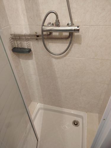 a shower in a bathroom with a tub and a shower head at Chez Pam et David in Saint-Maixent-lʼÉcole
