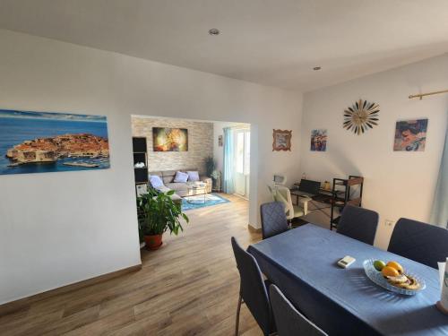 a living room with a dining table and a living room at Apartment Golden Oak in Dubrovnik