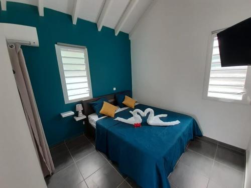 Postel nebo postele na pokoji v ubytování Gîte Passion Kréyol, Vue mer et montagne, SPA privé
