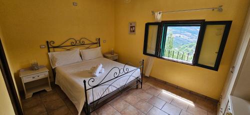 a bedroom with a white bed and a window at DE LERMA by Keyhole Selection in Castelmezzano