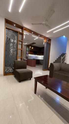 a living room with a couch and a coffee table at Elva villa-A luxurious 3bhk home stay near KPHB in Hyderabad