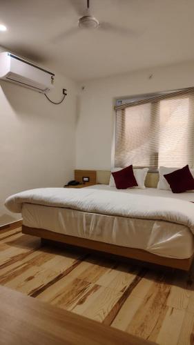 a large bed sitting in a room with at Bhoomi Palace Hotel And Bellas Bites Restaurant in Gorakhpur