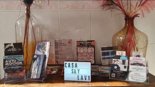 a shelf with two vases and books on a table at Llano del Beal in El Descargador