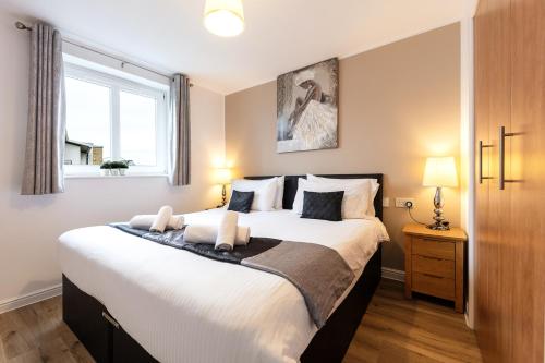 a bedroom with a large bed and a window at Jacobs Apartment Edinburgh in Edinburgh