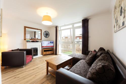 a living room with a couch and a television at Jacobs Apartment Edinburgh in Edinburgh