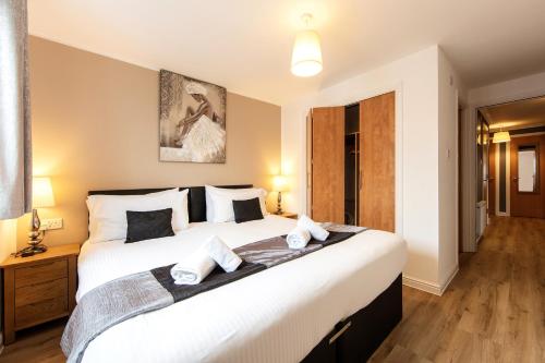 a bedroom with a large white bed with two pillows at Jacobs Apartment Edinburgh in Edinburgh