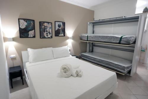 a bedroom with a bed and bunk beds in it at Casa Noal - a due passi da Ortigia e dal mare in Syracuse