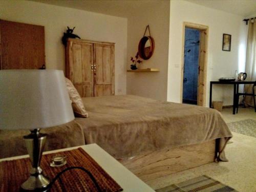 a bedroom with a bed and a table with a lamp at B&B petracountryhouse in Wadi Musa