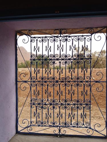 an open window with a view of a field at Gîte Palma Eagle Ziz Canyon in Er Rachidia