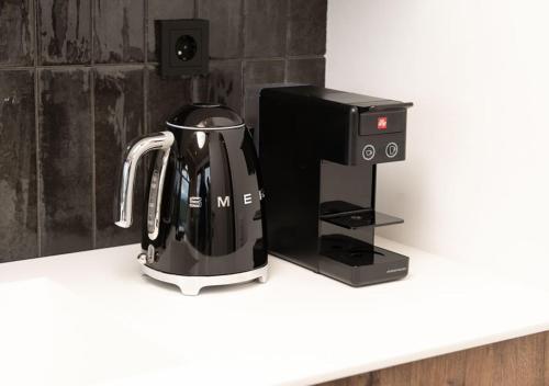 a coffee maker sitting on a counter next to a coffeeinder at Shakaryan Rancho&Restaurant in Dsegh