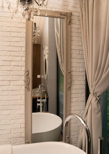 a bathroom with a tub and a sink and a mirror at Shakaryan Rancho&Restaurant in Dsegh