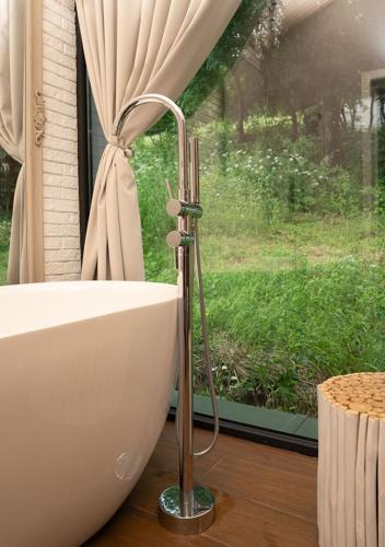 a bath tub sitting in front of a window at Shakaryan Rancho&Restaurant in Dsegh