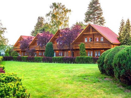 a large wooden house with a large yard at Neptun Ψ Domki - Jastrzębia Góra Centrum in Władysławowo