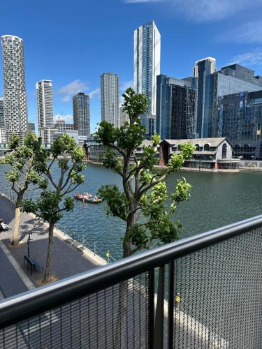 a view of a river in a city with buildings at Canary Wharf - Luxury Apartments in London