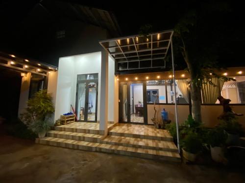 a house with stairs and lights in the night at Căn hộ cho 2-3 gia đình in Buôn Dhă Prŏng
