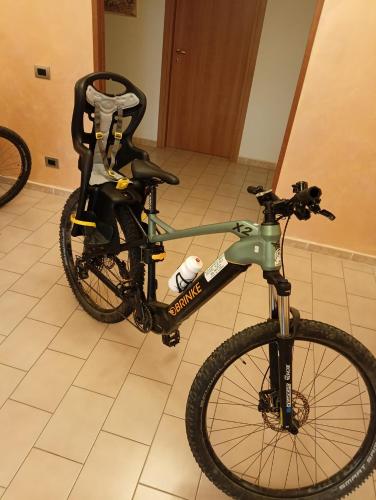 a bike is parked in a room at Hotel Aquila in Scoppito