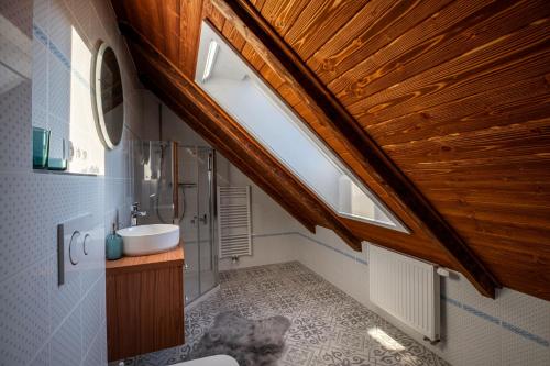 a bathroom with a sink and a wooden ceiling at Chaloupka Radovina 