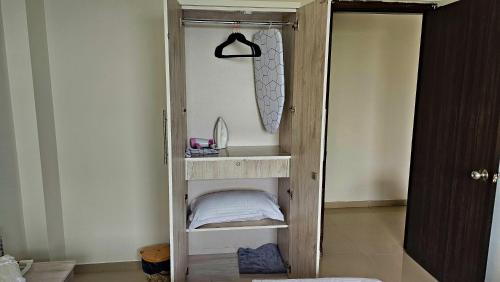 a room with a wooden shelf with a mirror at Luxury AC 2BHK Full Furnished with Sunrise View, Hill View, Pool, Kitchen, Ergonomic Workstation in Hinjewadi