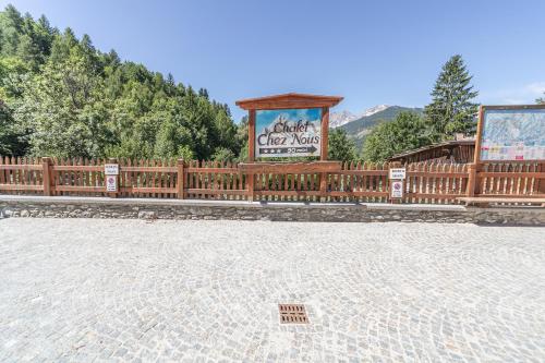 a wooden fence with a sign on it at Chalet Chez Nous in Sauze dʼOulx