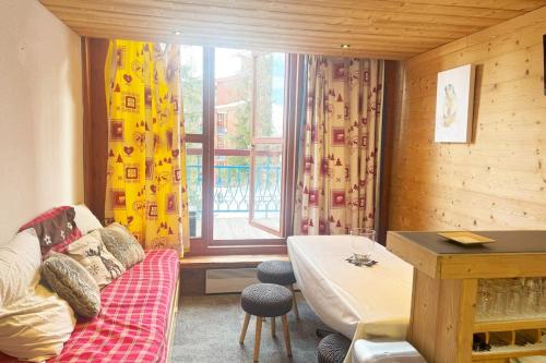a living room with a couch and a window at Appartement 6 personnes ARC 1800 in Bourg-Saint-Maurice
