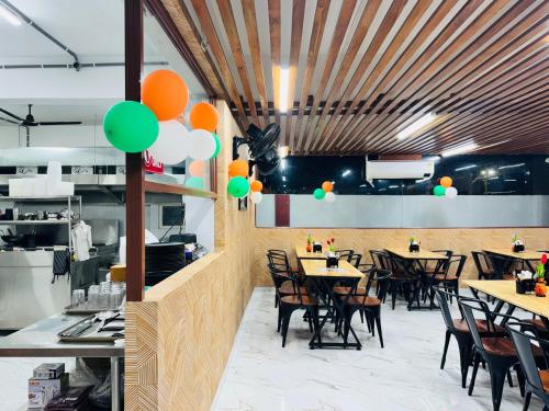 a restaurant with wooden ceilings and tables and chairs at HOTEL HYDERABAD PULSE in Shamshabad