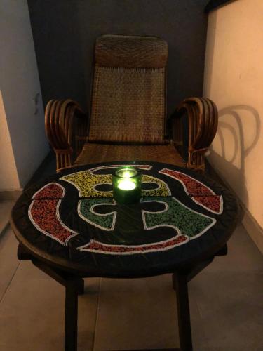 a candle sitting on top of a chair with a table at Tesla 30 in Kruševac