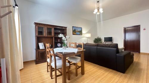 a living room with a table and a couch at Sea and Sun 4 You - Villa Jardim in Santana