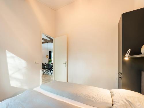 a bedroom with a bed and a mirror at Holiday Home in Hellendoorn near Forest in Hellendoorn
