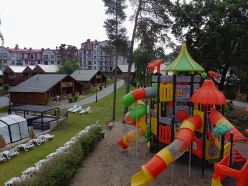 a park with a playground with a play equipment at Morska Osada domki blisko morza in Krynica Morska