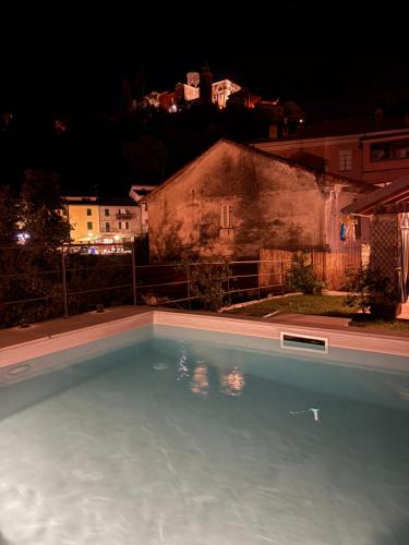 a large swimming pool in a yard at night at La Piscina nel Borgo in Bagnone