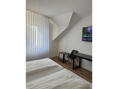a bedroom with a bed and a desk at Hotel & Restaurant Frechen in Frechen