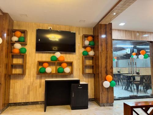 a living room with a television and balloons on the wall at HOTEL HYDERABAD PULSE in Shamshabad