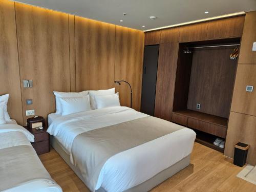a hotel room with two beds and a window at 해운대 웨이브 Haeundae wave in Busan