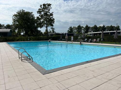 a large swimming pool with blue water at Recreatie Chalet in Dordrecht