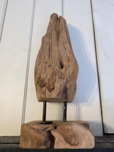 a rock sitting on a stand on a table at Direkt am See mit privatem Sandstrand in Güster