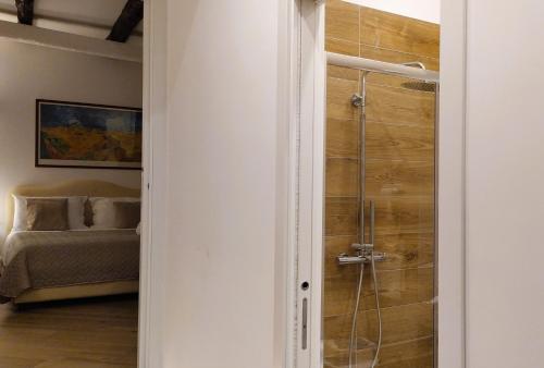 a bathroom with a shower in a room with a bed at Perca39 Casa nel cuore di Napoli, zona Sanità in Naples