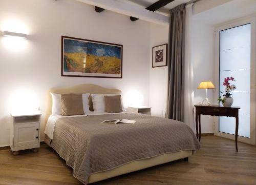 a bedroom with a bed and a table and a window at Perca39 Casa nel cuore di Napoli, zona Sanità in Naples