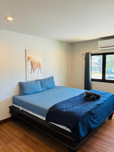 バン・コー・クワンにあるApartment Wat Sawang Arom 09の猫が寝ているベッドのある寝室