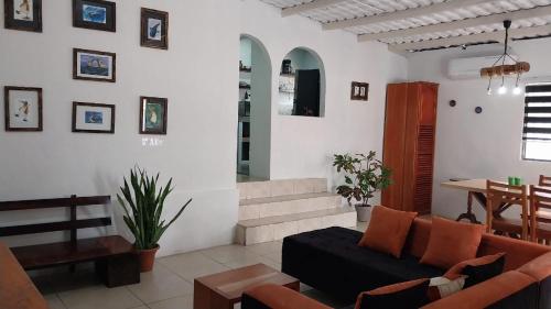 a living room with a couch and a table at Genovesa Family home in Puerto Ayora