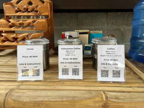 a table with three labels on top of jars at Himmapun Farmstay in Ban Pa Ngiu