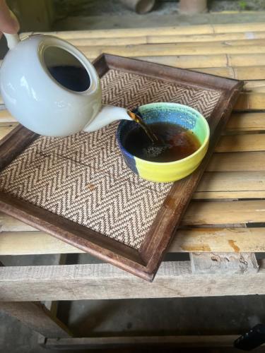 a cup of coffee on a tray with a cup of coffee at Himmapun Farmstay in Ban Pa Ngiu