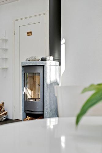 a kitchen with an oven in the middle of a room at Charmigt havsnära boende på Österlen in Simrishamn