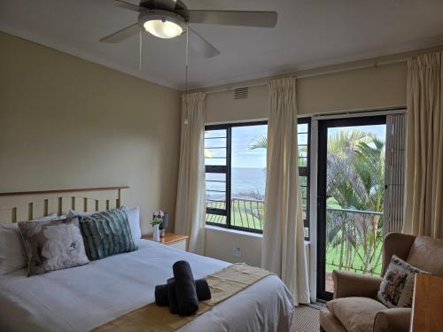 a bedroom with a bed and a large window at 13 Seaverge in Port Edward