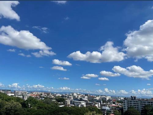 a city skyline with a blue sky and clouds at Chomdoi Condominium in Chiang Mai