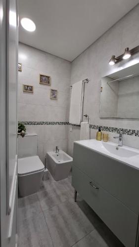a bathroom with a sink and a tub and a toilet at Thouse Fontainhas in Cascais