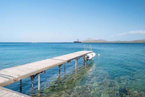 a dock in the middle of a body of water at Villa Smeralda Punta Lada Porto Rotondo in Porto Rotondo