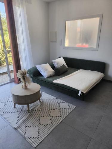 a living room with a couch and a table at Studio meublé Rosieres in Rosières