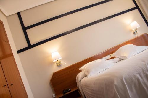 Postel nebo postele na pokoji v ubytování Hotel Olimpo